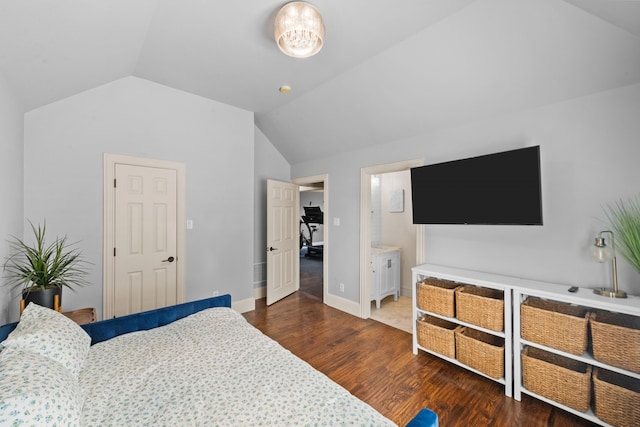 bedroom with lofted ceiling, connected bathroom, baseboards, and dark wood-style flooring