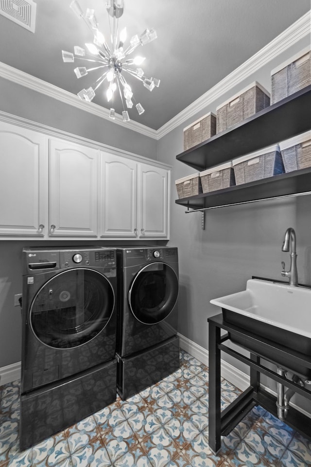 washroom featuring visible vents, cabinet space, washer and clothes dryer, an inviting chandelier, and crown molding