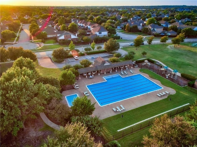 pool featuring a patio area, fence, and a residential view