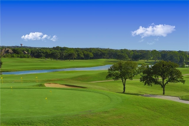 view of property's community with a water view, golf course view, and a yard