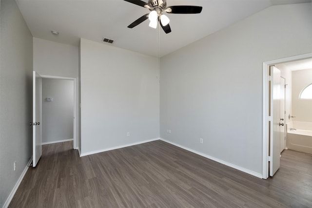 unfurnished bedroom featuring ensuite bathroom, dark wood-style flooring, a ceiling fan, visible vents, and baseboards