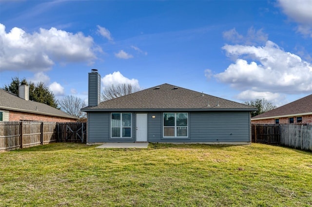 back of house with a patio area, a fenced backyard, a chimney, and a lawn