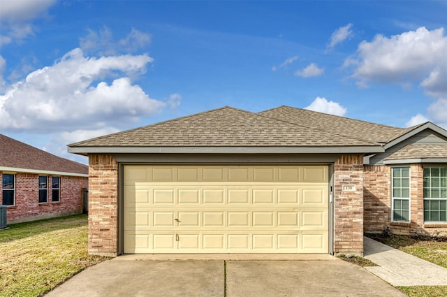 view of front facade featuring central AC, driveway, brick siding, and roof with shingles