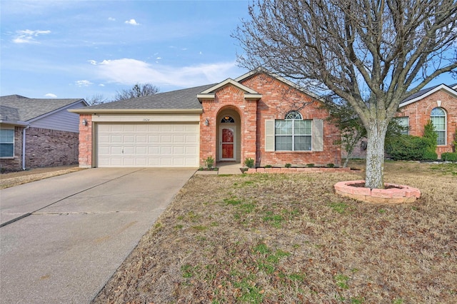 ranch-style home with a garage, driveway, brick siding, and a shingled roof