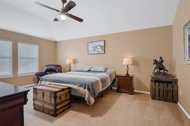 bedroom with ceiling fan, baseboards, vaulted ceiling, and light colored carpet