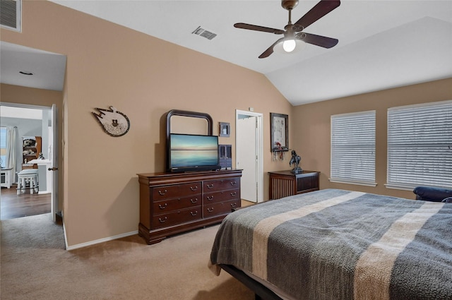 carpeted bedroom with lofted ceiling, baseboards, visible vents, and ceiling fan