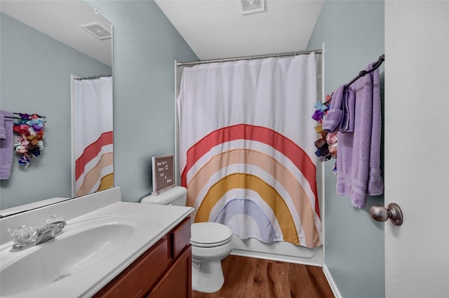 full bathroom featuring visible vents, vanity, toilet, and wood finished floors