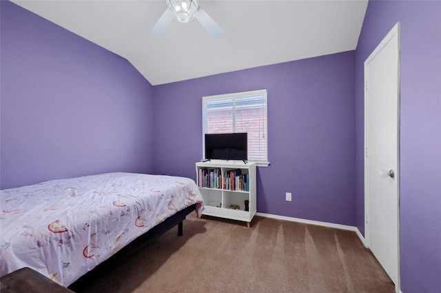 bedroom with carpet flooring, vaulted ceiling, baseboards, and ceiling fan