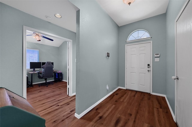 foyer entrance with ceiling fan, wood finished floors, and baseboards