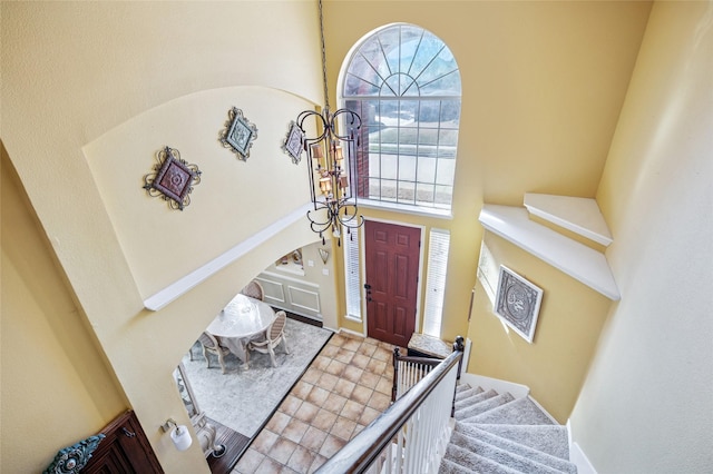 foyer with a towering ceiling and stairs