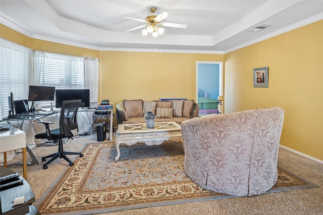 interior space featuring a ceiling fan, carpet, a raised ceiling, and visible vents