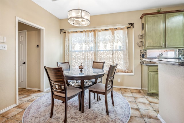 dining room featuring an inviting chandelier, light tile patterned floors, and baseboards