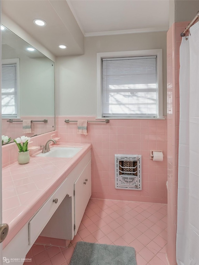 bathroom with crown molding, tile walls, heating unit, vanity, and tile patterned flooring