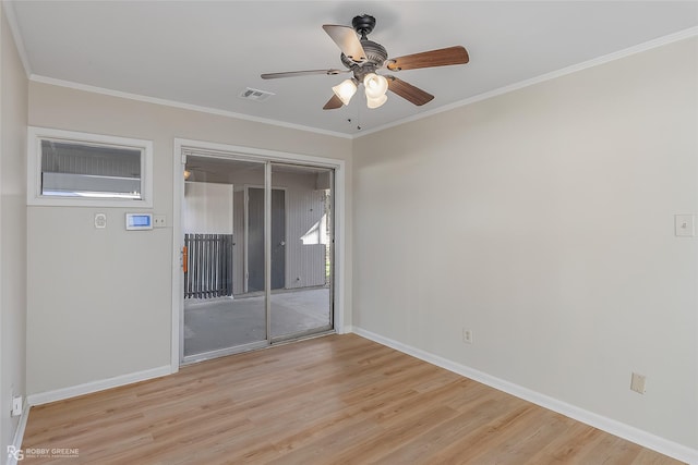 spare room featuring visible vents, crown molding, light wood-style flooring, and baseboards