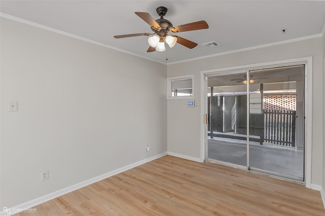 unfurnished room featuring ornamental molding, visible vents, light wood-style flooring, and baseboards