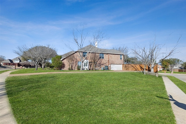 view of front of home featuring a garage and a front lawn