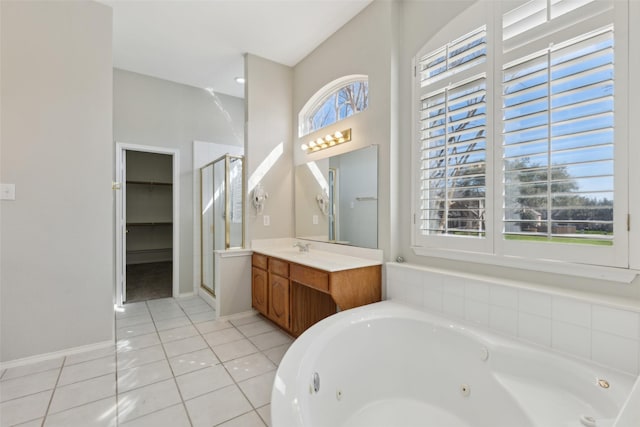 bathroom with vanity, baseboards, a jetted tub, tile patterned floors, and a stall shower