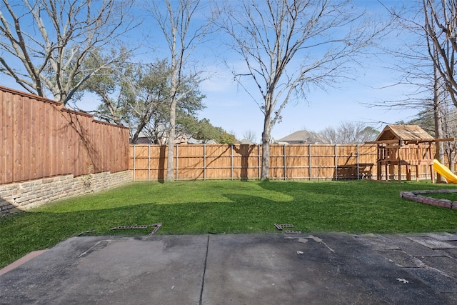 view of yard with a playground and a fenced backyard