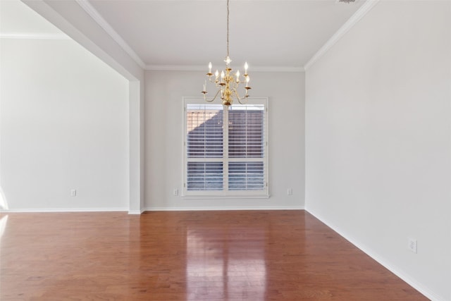 unfurnished dining area with baseboards, ornamental molding, a notable chandelier, and wood finished floors