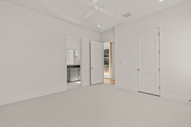 unfurnished bedroom with connected bathroom, recessed lighting, light colored carpet, visible vents, and baseboards