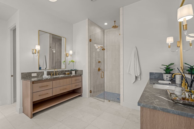 bathroom with a shower stall, baseboards, and vanity