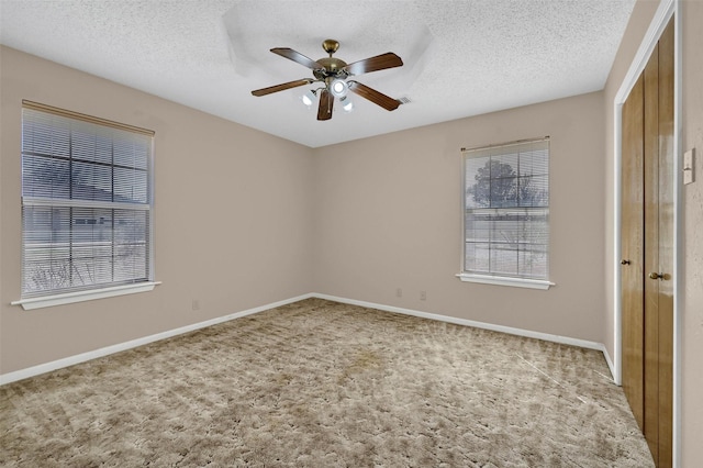 268 Roland Rd, Whitesboro, TX 76273 - unfurnished bedroom featuring a textured ceiling, carpet flooring, a ceiling fan, baseboards, and a closet