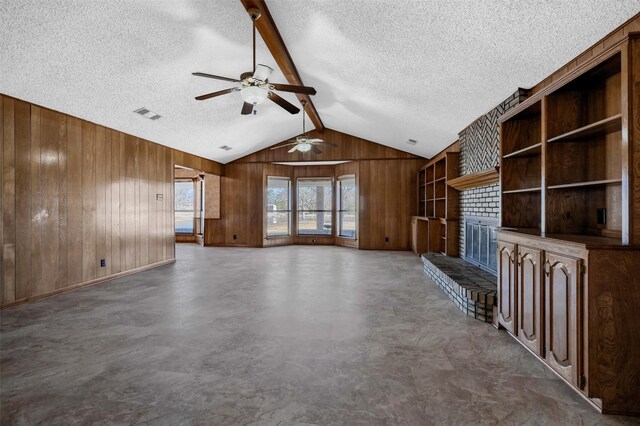 268 Roland Rd, Whitesboro, TX 76273 - unfurnished living room featuring lofted ceiling with beams, wood walls, a textured ceiling, and visible vents