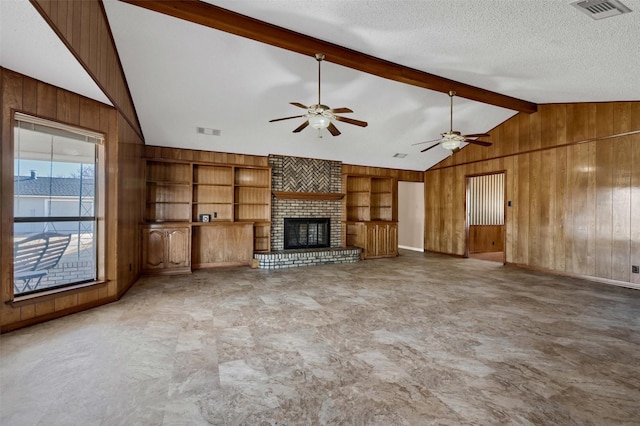 268 Roland Rd, Whitesboro, TX 76273 - unfurnished living room featuring lofted ceiling with beams, wood walls, visible vents, and a textured ceiling