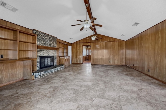 268 Roland Rd, Whitesboro, TX 76273 - unfurnished living room featuring lofted ceiling with beams, wood walls, a brick fireplace, and visible vents