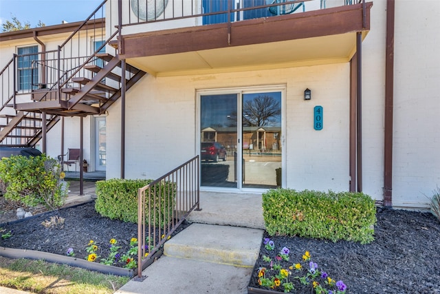 entrance to property featuring brick siding