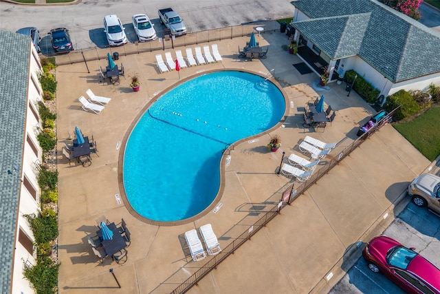 community pool featuring a patio area and fence