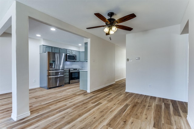 unfurnished living room featuring baseboards, ceiling fan, recessed lighting, and light wood-style floors