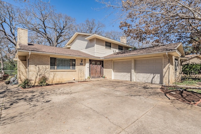 view of front of house featuring brick siding, a chimney, concrete driveway, fence, and a garage