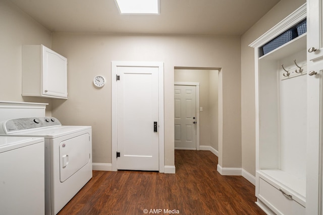 washroom with dark wood-style flooring, washing machine and clothes dryer, cabinet space, and baseboards