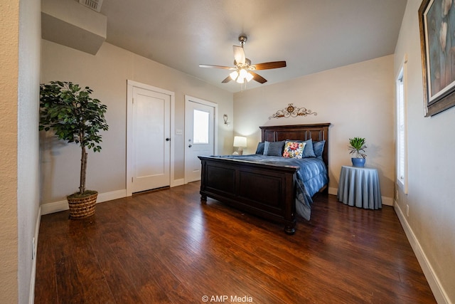 bedroom featuring a ceiling fan, baseboards, and wood finished floors