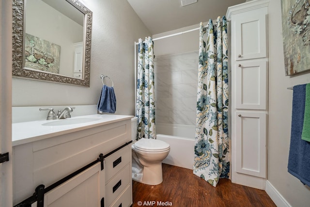 bathroom featuring visible vents, toilet, shower / bath combo with shower curtain, vanity, and wood finished floors