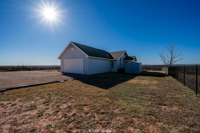 view of home's exterior featuring a garage, a yard, and fence