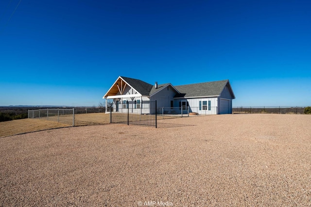 view of front of home with a garage, fence private yard, and a gate