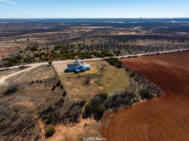 birds eye view of property with a rural view