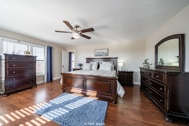 bedroom with dark wood-style floors, ceiling fan, and baseboards