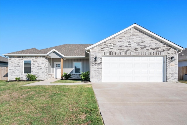 ranch-style home with an attached garage, fence, driveway, board and batten siding, and a front yard