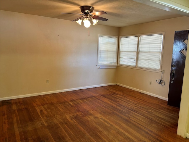spare room with hardwood / wood-style flooring, baseboards, and a ceiling fan