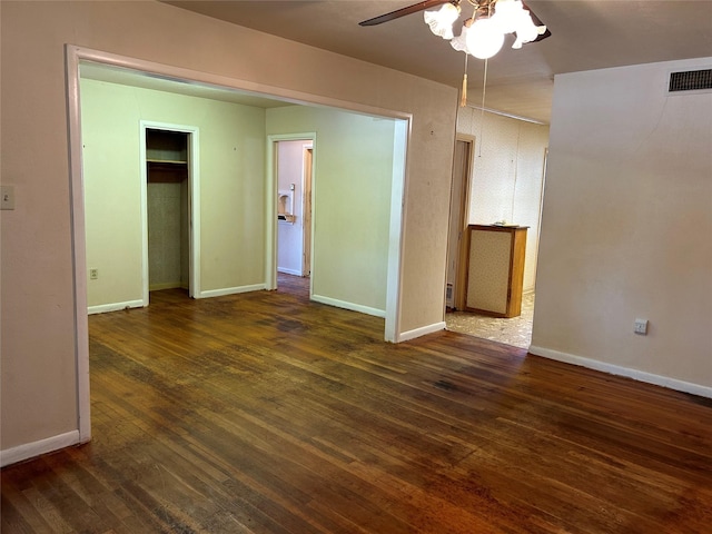 interior space featuring visible vents, ceiling fan, baseboards, and hardwood / wood-style flooring