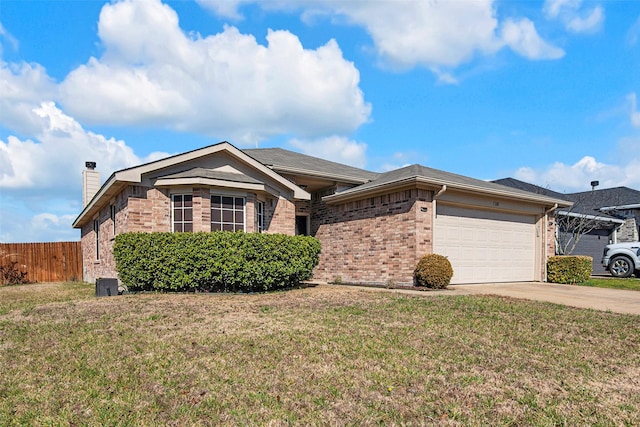 ranch-style home with driveway, an attached garage, fence, and a front yard