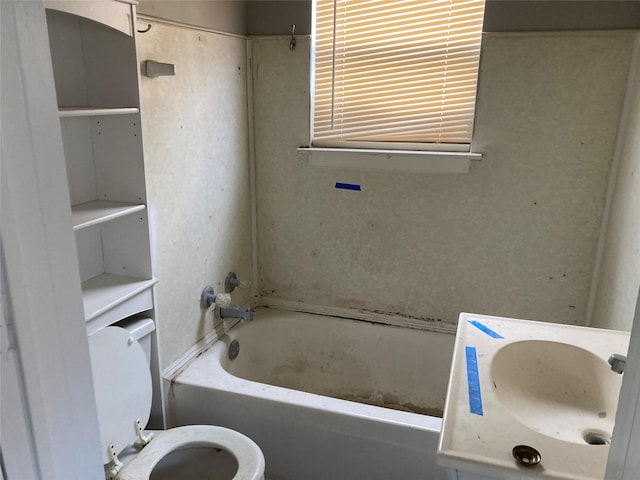 bathroom featuring a sink, toilet, and a bathing tub