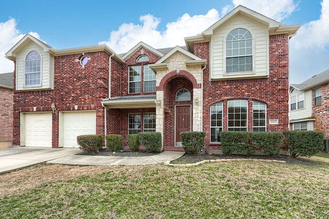 traditional-style home featuring a garage, brick siding, driveway, and a front lawn