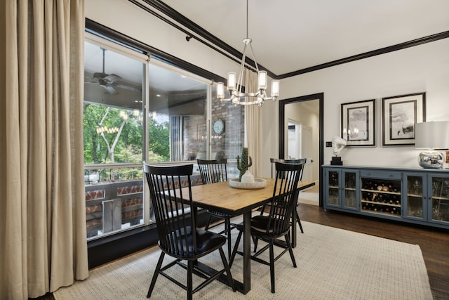 dining space featuring ceiling fan with notable chandelier, ornamental molding, and wood finished floors