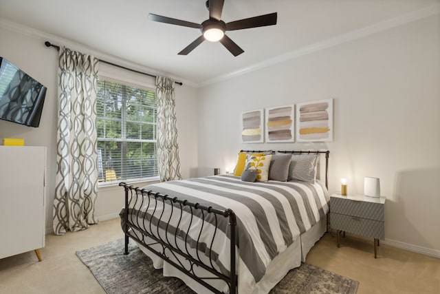 bedroom featuring light carpet, ceiling fan, baseboards, and crown molding