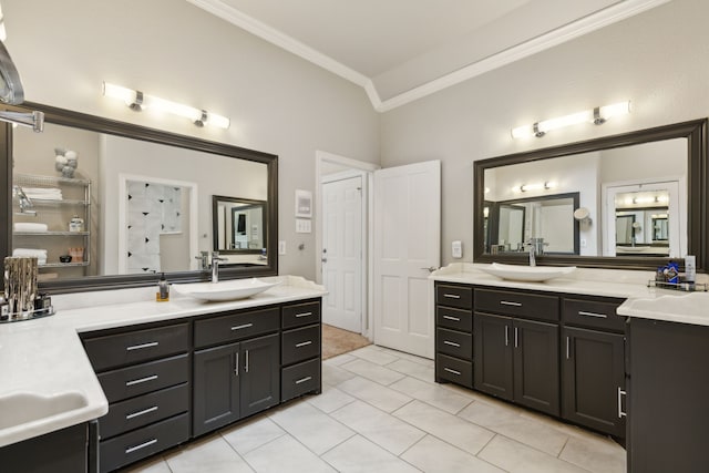 full bath featuring ornamental molding, two vanities, a sink, and tile patterned floors