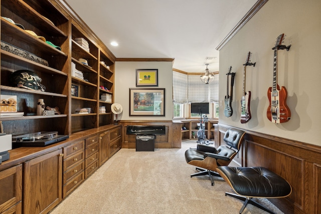 office with carpet floors, a wainscoted wall, crown molding, and a notable chandelier